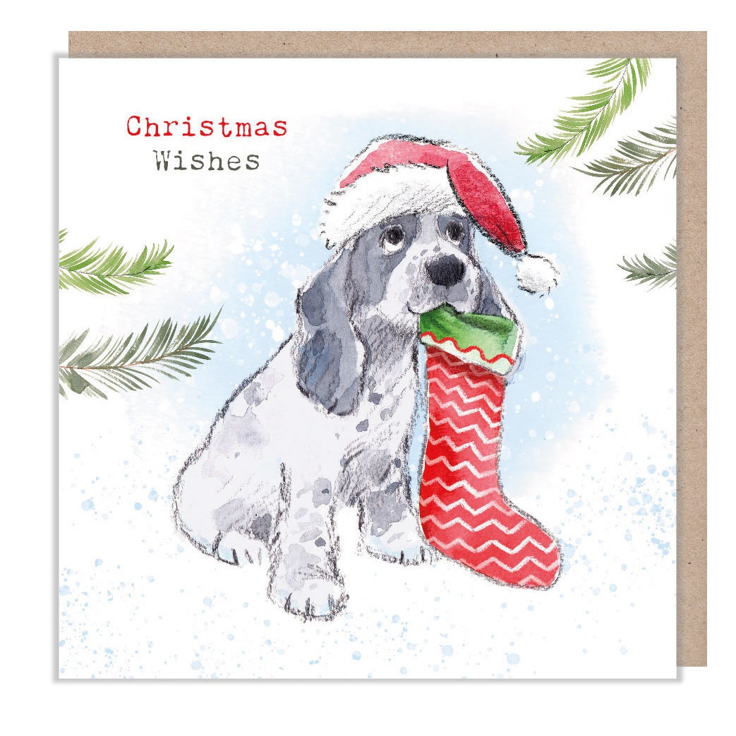 Christmas Card - Black & White Cocker Spaniel, Wearing Hat and Holding Christmas Stocking in It's Mouth. Christmas Wishes